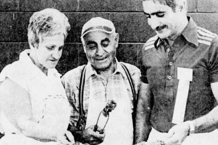 Harry Seraganian, Marguerite Kollostain, and Ron Moshoian preparing food to be served at the Armenian Villiage.png